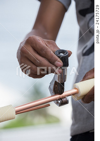 worker cutting copper pipe of air conditioner worker cutting copper pipe of air conditioner 24175729