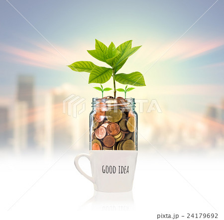 Gold coins and seed in clear bottle over the glass with text good idea on photo blurred cityscape background,Business investment growth concept Gold coins and seed in clear bottle over the glass with text good idea on photo blurred cityscape background,Business investment growth concept 24179692