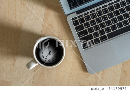 Top view of Laptop, notepad and coffee cup which shown time over surface wooden background,flat lay 24179975