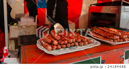 grilled sausage on white plate in market. 24184488