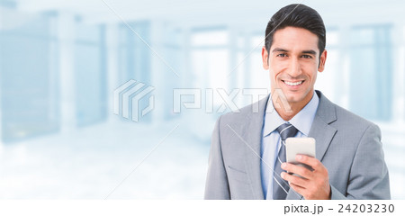 Composite image of businessman using mobile phone with colleague 24203230