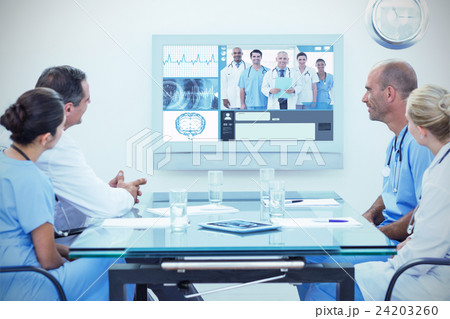 Composite image of team of doctors having a meeting Composite image of team of doctors having a meeting 24203260