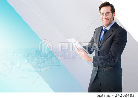 Composite image of businessman looking at the camera while using 24203483