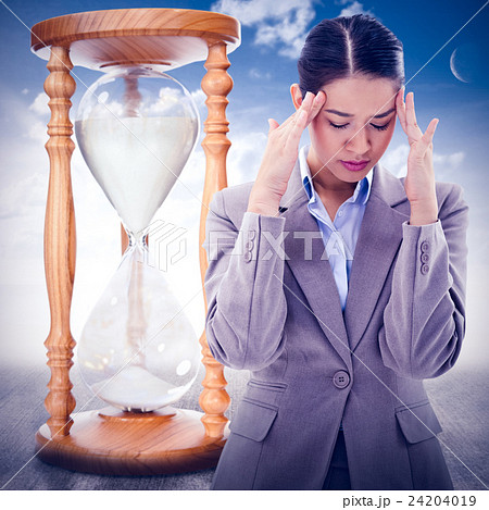 Composite image of portrait of a beautiful businesswoman having a headache Composite image of portrait of a beautiful businesswoman having a headache 24204019