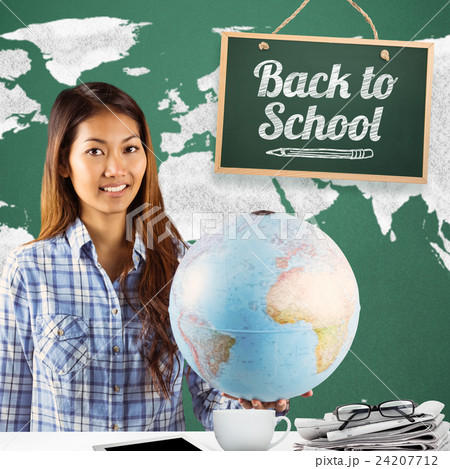 Composite image of smiling asian woman holding a globe Composite image of smiling asian woman holding a globe 24207712