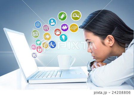 Composite image of worried businesswoman in front of her laptop  24208806