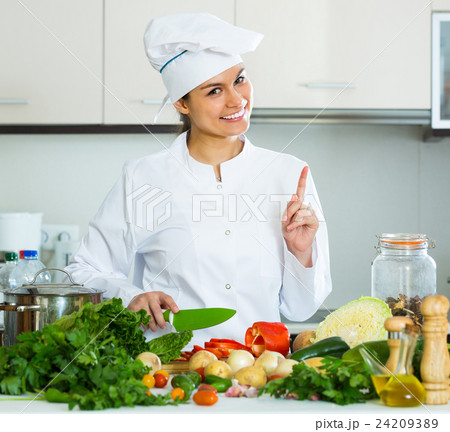 Woman in uniform at kitchen 24209389