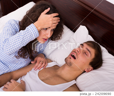Awake woman watching snorring husband at night Awake woman watching snorring husband at night 24209690