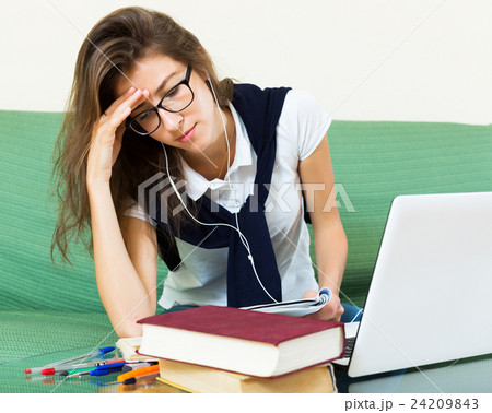 Unhappy girl behind her laptop Unhappy girl behind her laptop 24209843