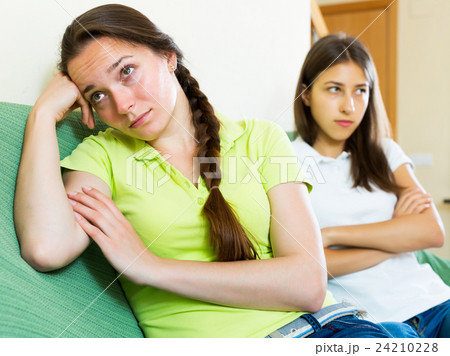 Woman friends sitting and discontent 24210228
