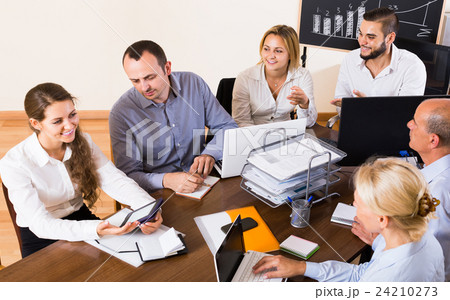 colleagues discussing price development at office colleagues discussing price development at office 24210273