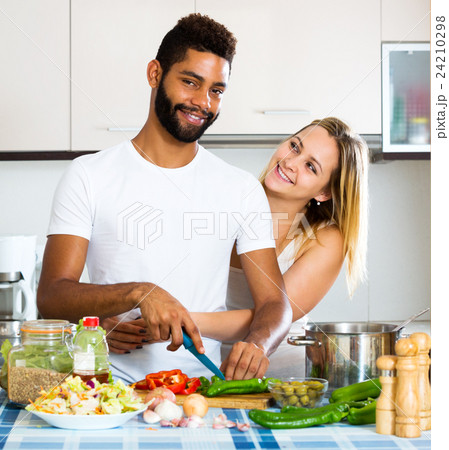 Husband helping wife preparing healthy dinner Husband helping wife preparing healthy dinner 24210298