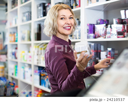 Portrait of mature store clerk at household and cosmetic shop Portrait of mature store clerk at household and cosmetic shop 24210537