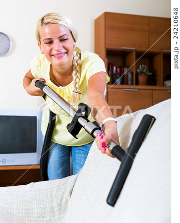 girl hoovering in living room 24210648