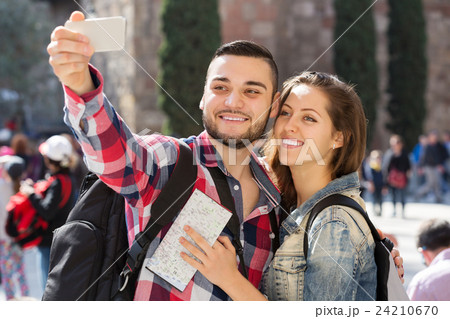 Couple with luggage doing selfie Couple with luggage doing selfie 24210670