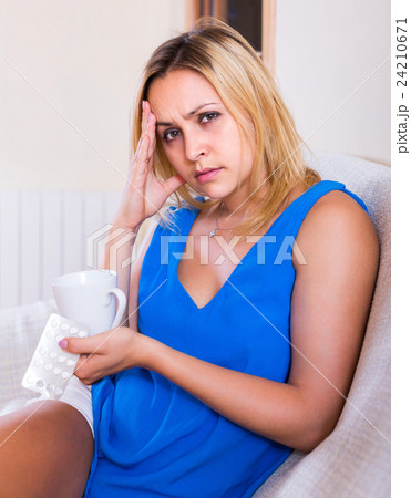 Young woman with pills at home Young woman with pills at home 24210671