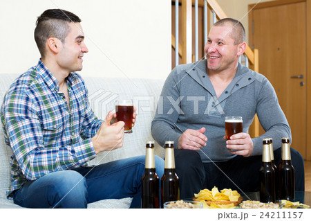 Two men drinking beer 24211157