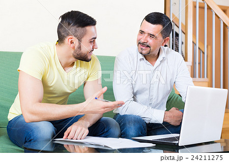 Two men with laptop at home 24211275