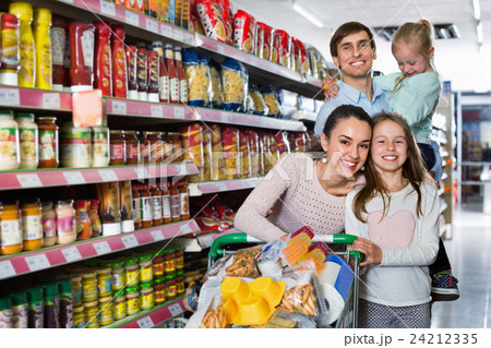 Charming customers with children buying food in hypermarket Charming customers with children buying food in hypermarket 24212335