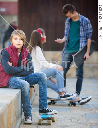 teen and his friends after conflict outdoors 24212827