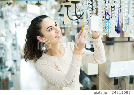 Ordinary woman doing shopping in lighting shop Ordinary woman doing shopping in lighting shop 24213095