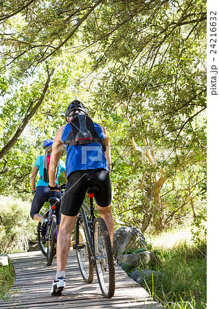 Senior couple standing with their bikes Senior couple standing with their bikes 24216632