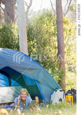 Mature woman laying and calling on the phone  24216820