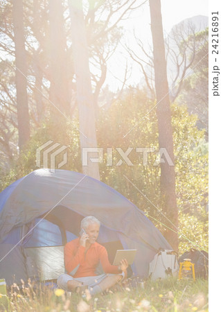 Mature man holding tablet and calling on the phone  24216891