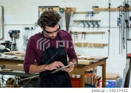 Carpenter is using his tablet Carpenter is using his tablet 24217432