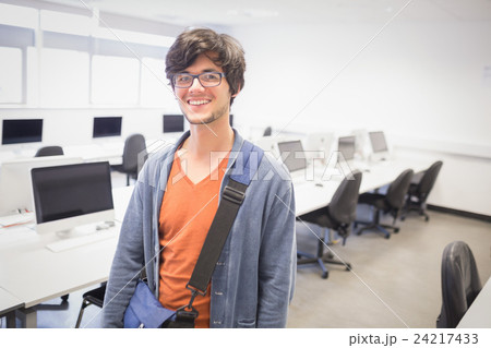 Portrait of happy student standing in computer class 24217433