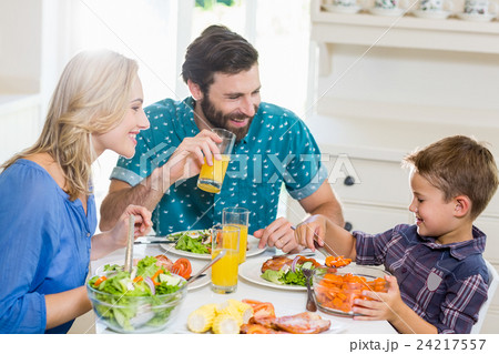 Family having meal in kitchen 24217557