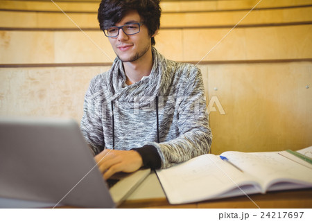 Young student using laptop in classroom Young student using laptop in classroom 24217697