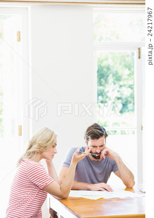 Worried young couple checking on bills Worried young couple checking on bills 24217967