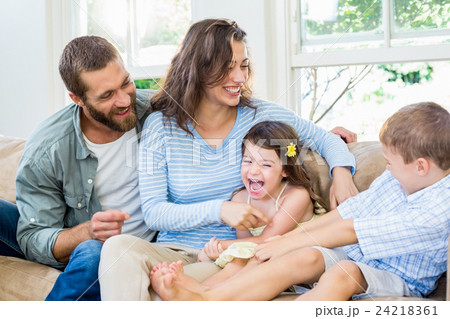 Parents and kids sitting on sofa and having fun Parents and kids sitting on sofa and having fun 24218361