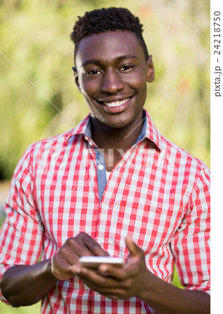 Happy man using his smartphone Happy man using his smartphone 24218750