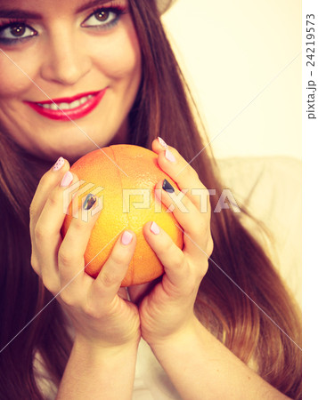 Woman holding grapefruit citrus fruit in hand Woman holding grapefruit citrus fruit in hand 24219573