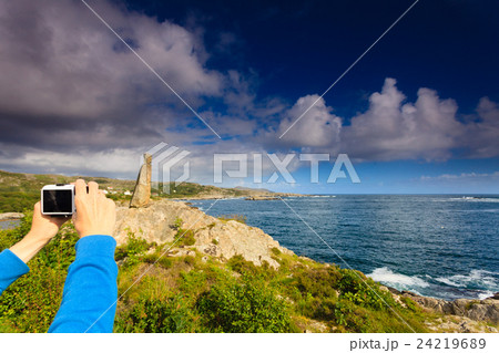 Woman tourist taking photo with camera in Norway 24219689