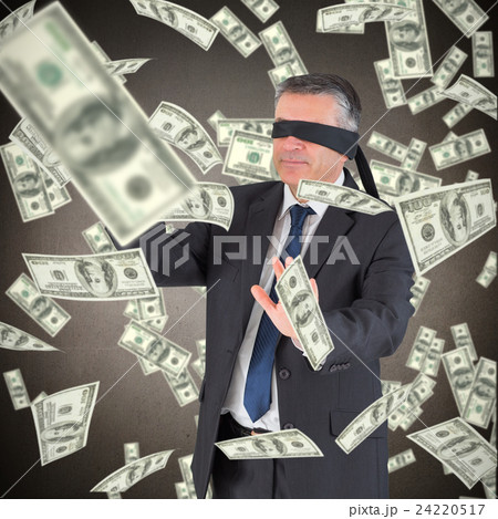 Composite image of mature businessman in a blindfold 24220517
