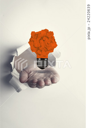 Composite image of hand presenting through paper Composite image of hand presenting through paper 24220639