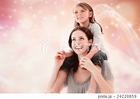 Composite image of cheerful mother giving piggyback ride to her daughter  24220859