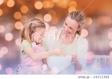 Composite image of mother and daughter having fun in the kitchen Composite image of mother and daughter having fun in the kitchen 24221369