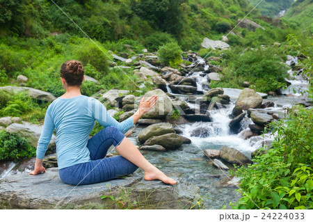 Woman doing Ardha matsyendrasanaasana asana Woman doing Ardha matsyendrasanaasana asana 24224033