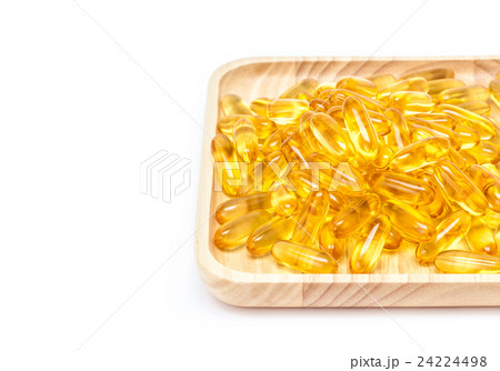 Fish oil capsules in wooden tray isolated on white Fish oil capsules in wooden tray isolated on white 24224498
