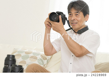 一眼レフカメラを持つ男性の写真素材