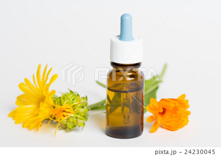 bottles with calendula oil on white 24230045
