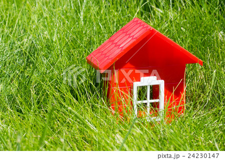 red plastic house on green grass 24230147