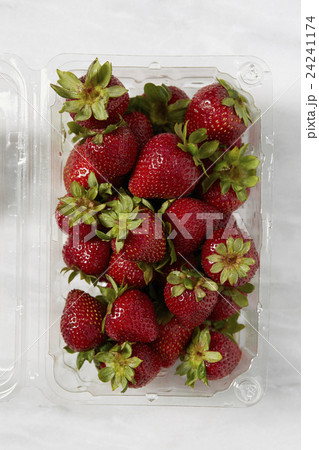 Overhead view of fresh strawberries in plastic container 24241174