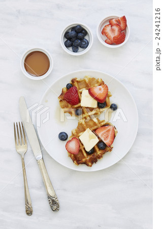 Overhead view of waffles with strawberries and blueberries 24241216