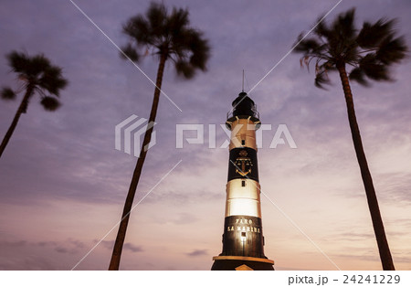 Peru, Lima, Miraflores, Faro De La Marina and palm trees at sunset 24241229