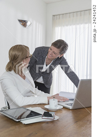 Discussion between businesswomen at work Discussion between businesswomen at work 24241452